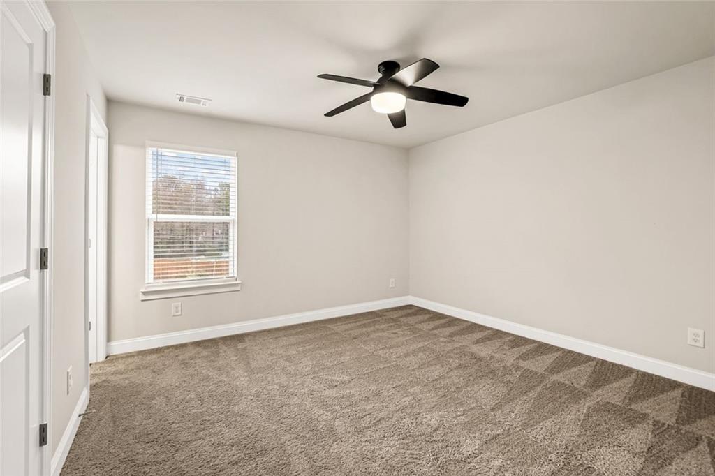 639 Tigers Eye Terrace Kennesaw, GA 30144 - Photo 24 of 36 an empty room with a window and a fan