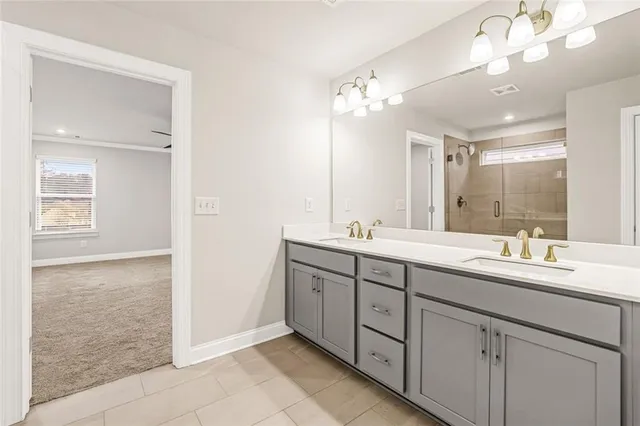 a bathroom with a double vanity sink a mirror and a shower