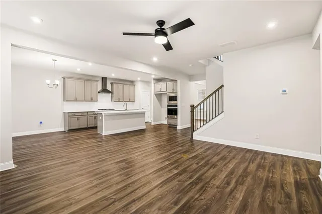a view of a kitchen with wooden floor and a sink