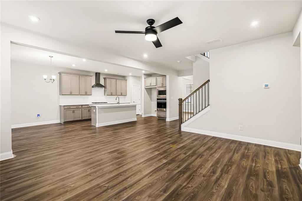 639 Tigers Eye Terrace Kennesaw, GA 30144 - Photo 3 of 36 a view of a kitchen with wooden floor and a sink