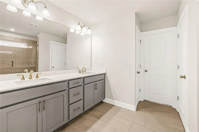 a bathroom with a double vanity sink and a mirror