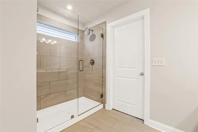 a bathroom with a glass shower door