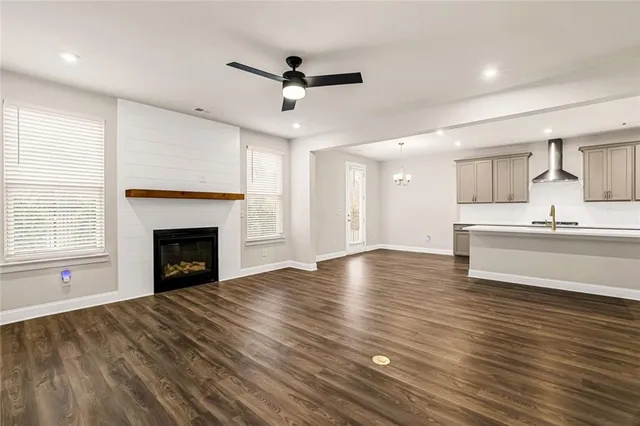 a view of an empty room with a window and fireplace
