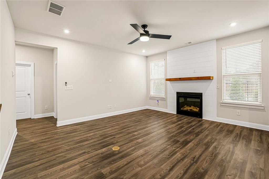 639 Tigers Eye Terrace Kennesaw, GA 30144 - Photo 5 of 36 a view of empty room with wooden floor and fireplace