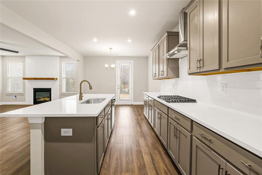 639 Tigers Eye Terrace Kennesaw, GA 30144 - Photo 6 of 36 a kitchen with stainless steel appliances granite countertop a sink a stove and a refrigerator