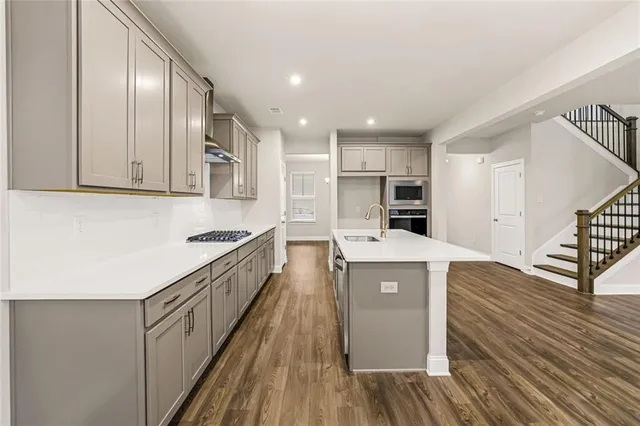 a kitchen with cabinets and wooden floor