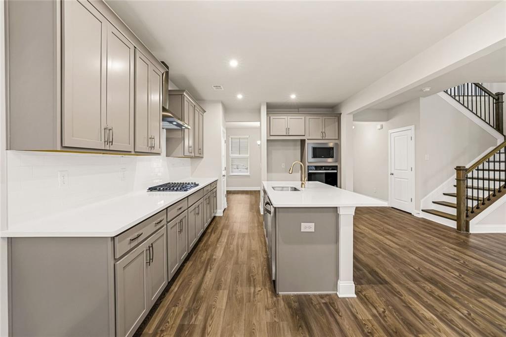 639 Tigers Eye Terrace Kennesaw, GA 30144 - Photo 8 of 36 a kitchen with cabinets and wooden floor