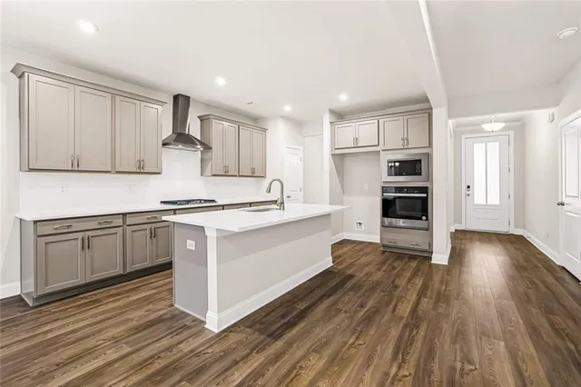 a kitchen with wooden floors and appliances