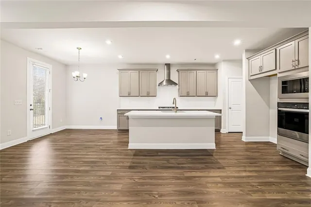 a view living room with stainless steel appliances kitchen island wooden floor and window