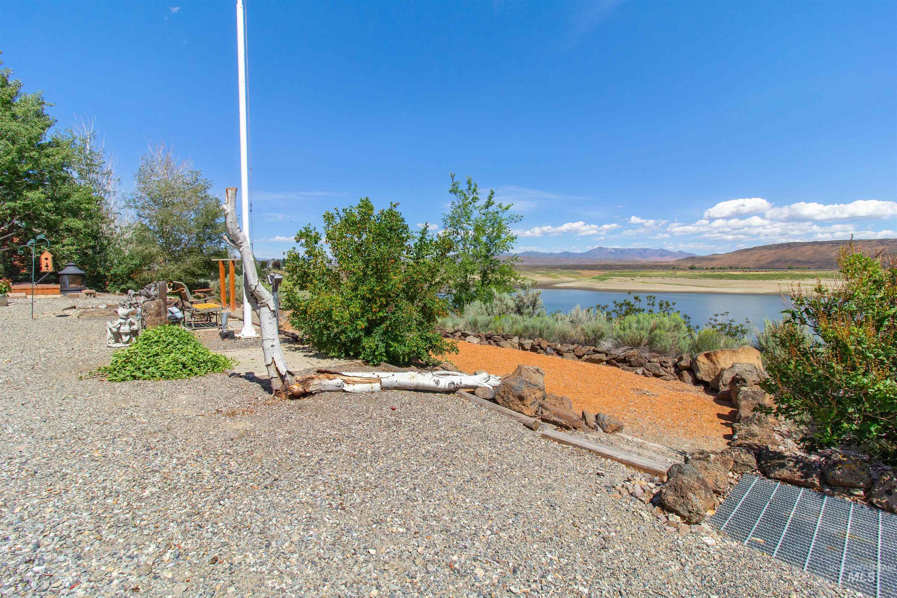 106 West Magic Road Shoshone, ID 83352 - Photo 36 of 45 Expansive gravel patio area featuring a flagpole and natural landscaping