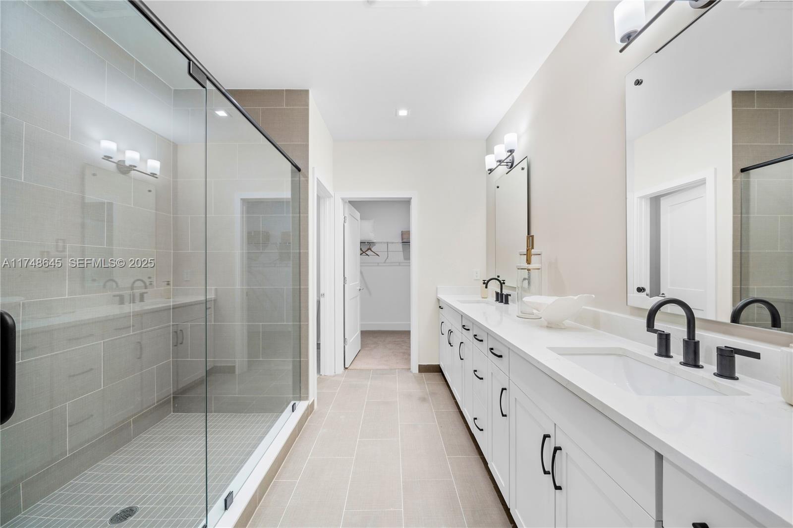 10951 Salt Bay Way Fort Myers, FL 33913 - Photo 21 of 34 a bathroom with a double vanity sink mirror and shower