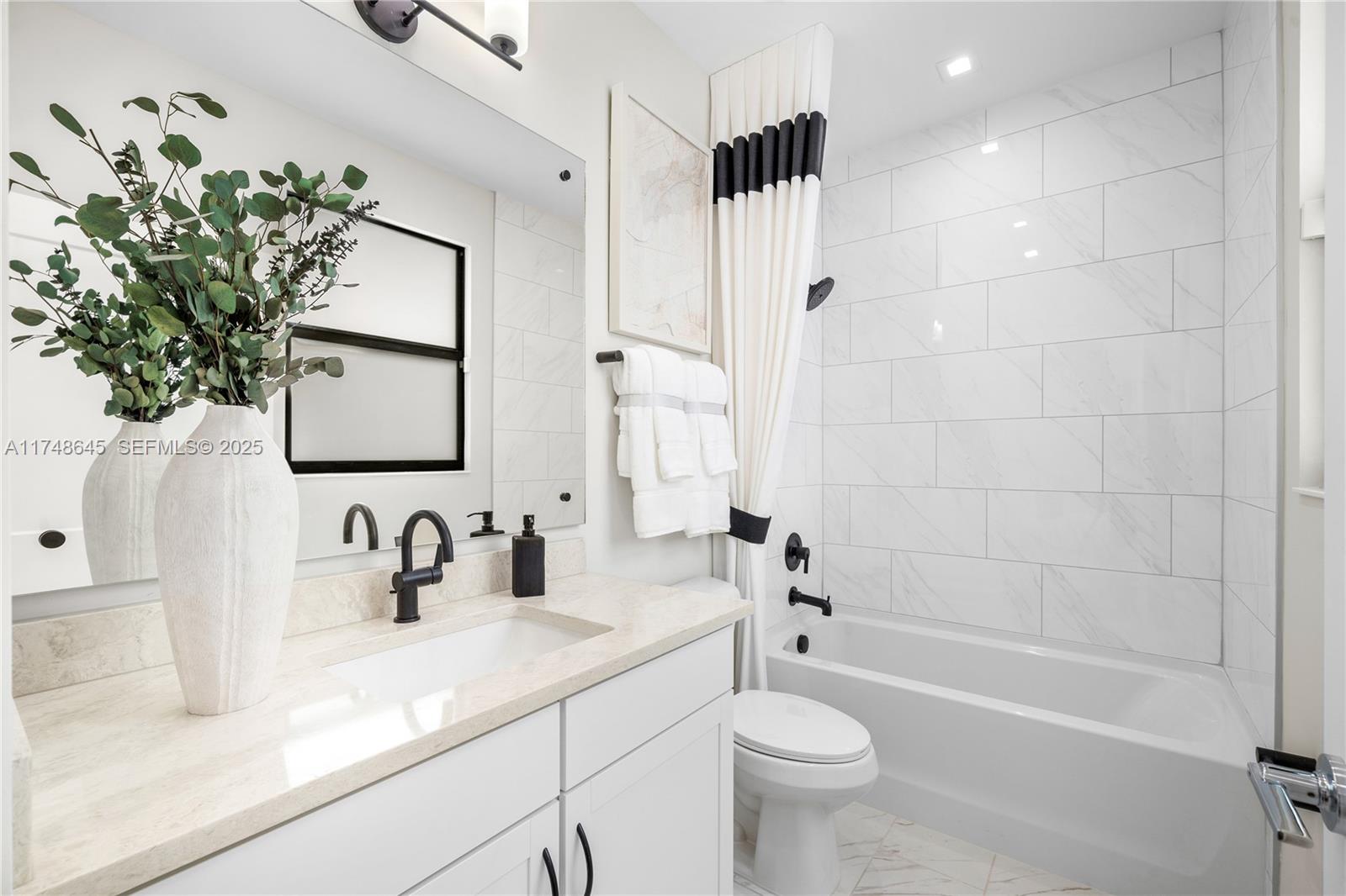 10951 Salt Bay Way Fort Myers, FL 33913 - Photo 27 of 34 a bathroom with a sink a toilet a tub and shower