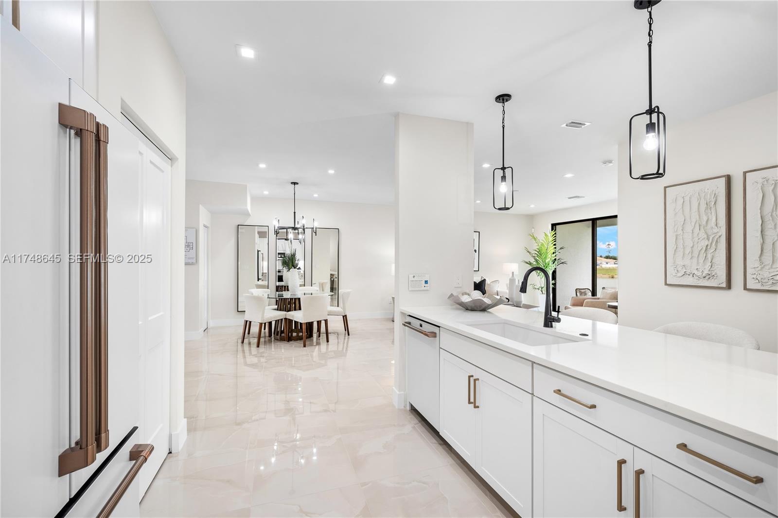 10951 Salt Bay Way Fort Myers, FL 33913 - Photo 3 of 34 a large white kitchen with a refrigerator a sink and a stove