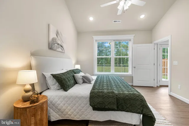 a bedroom with a bed and wooden floor