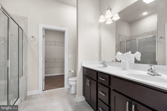 a bathroom with a double vanity sink and a mirror