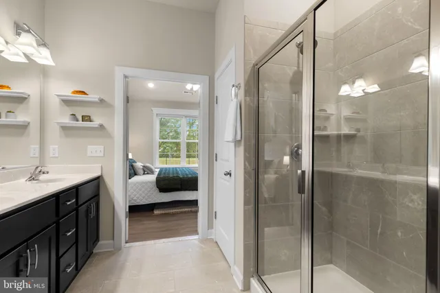 a en suite bathroom with a shower and a sink
