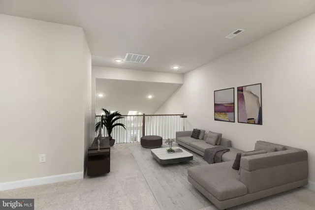 a living room with furniture and a ceiling fan