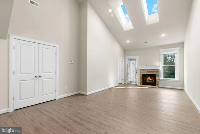 a view of a kitchen with stainless steel appliances granite countertop a sink and cabinets