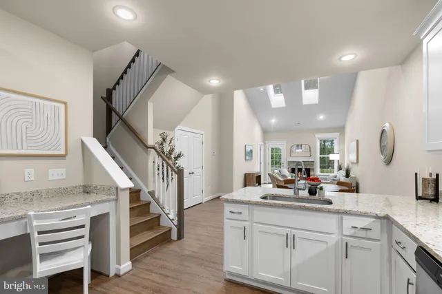 a very nice looking room with wooden floor and cabinets