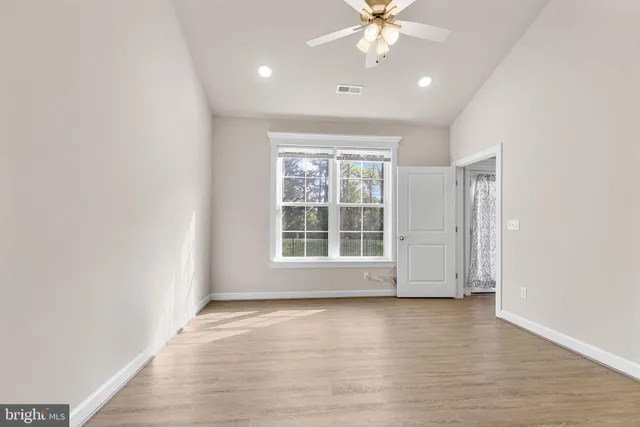 a view of a room with wooden floor