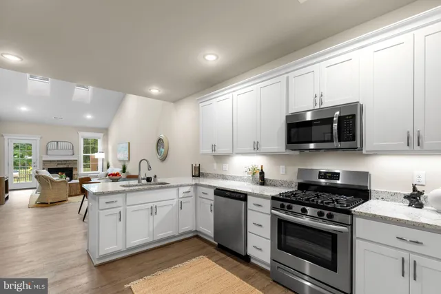 a kitchen with a sink stove top oven and cabinets