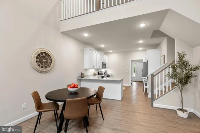 a dining room with furniture and a mirror