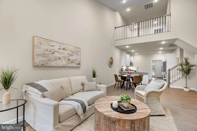a living room with furniture a view and a dining table with wooden floor