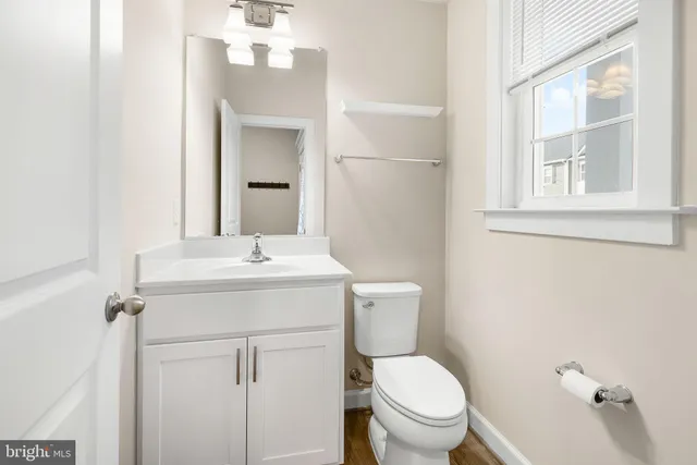 a bathroom with a toilet sink and mirror