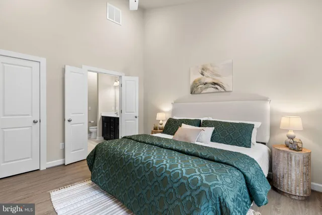 a bedroom with a bed and wooden floor