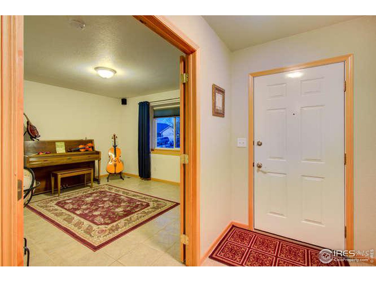 841 Durum Street Windsor, CO 80550 - Photo 4 of 24 a living room with a piano and a table