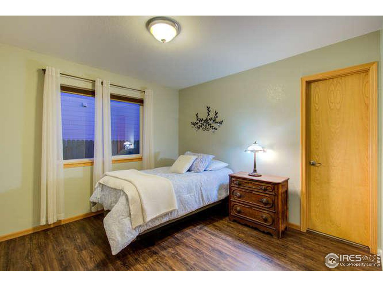 841 Durum Street Windsor, CO 80550 - Photo 7 of 24 a bedroom with a bed lamp and a dresser