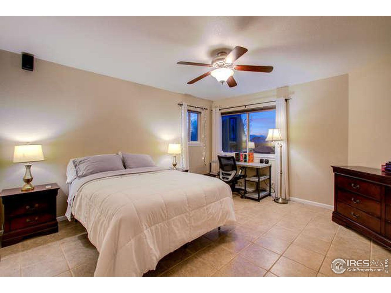 841 Durum Street Windsor, CO 80550 - Photo 9 of 24 a spacious bedroom with a bed a table and potted plants