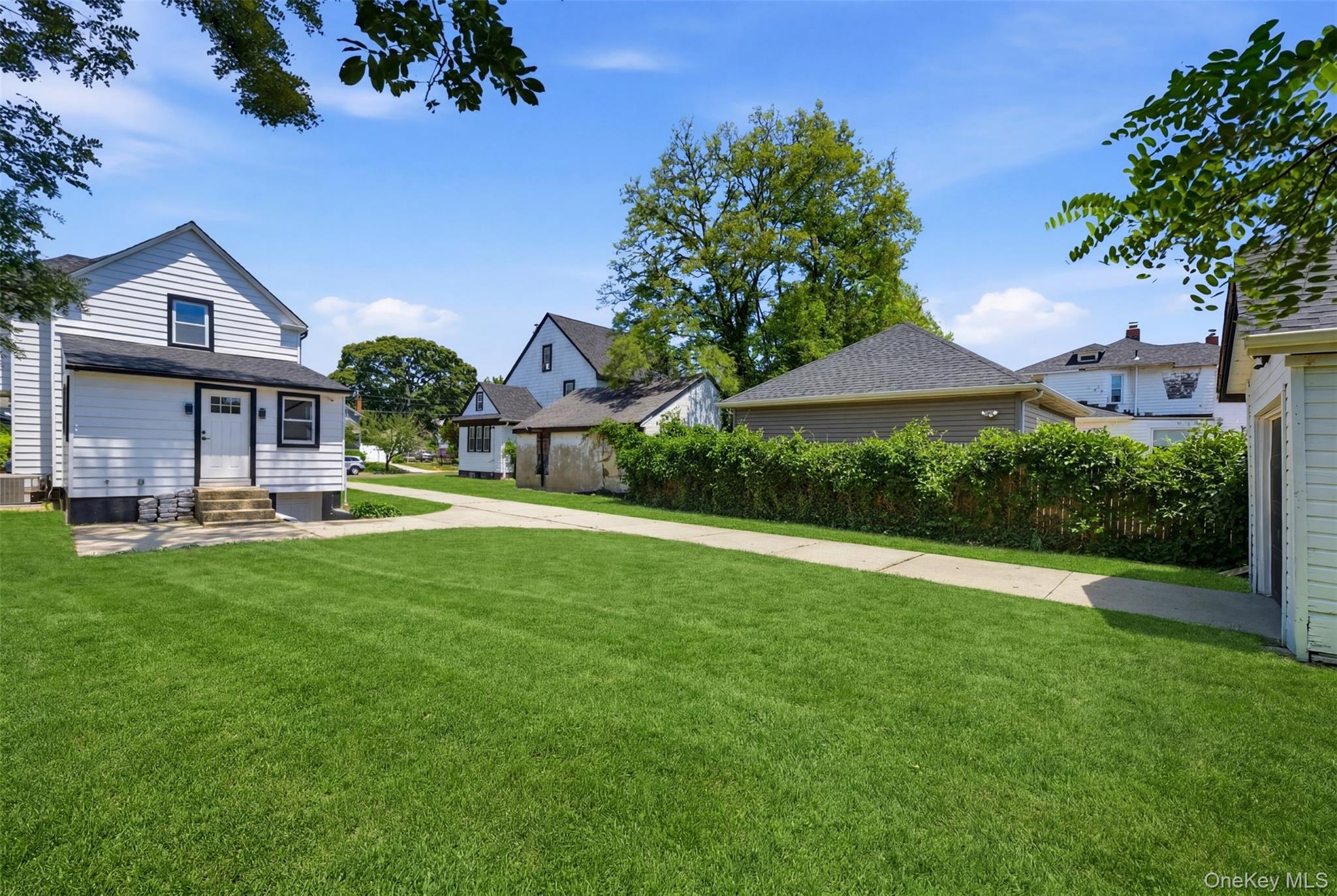 135 Whaley Street Freeport, NY 11520 - Photo 37 of 38 a front view of a house with yard and green space