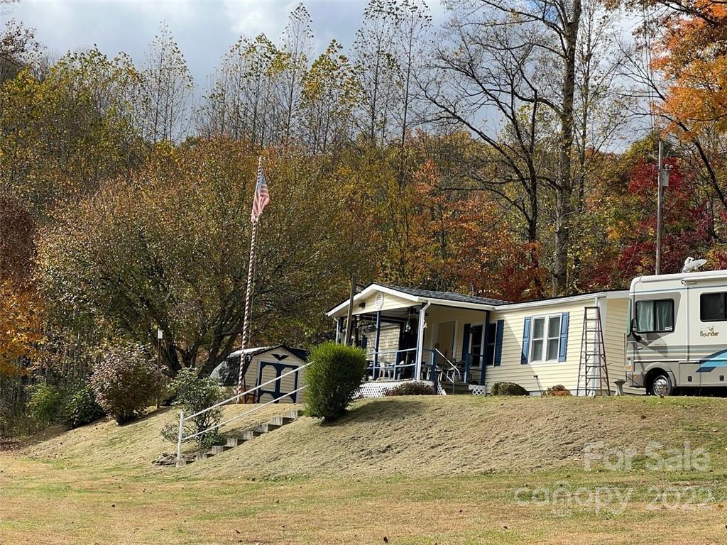 396 Jacobs Road Bryson City, NC 28713 - Photo 1 of 43 a front view of a house with a yard covered in snow