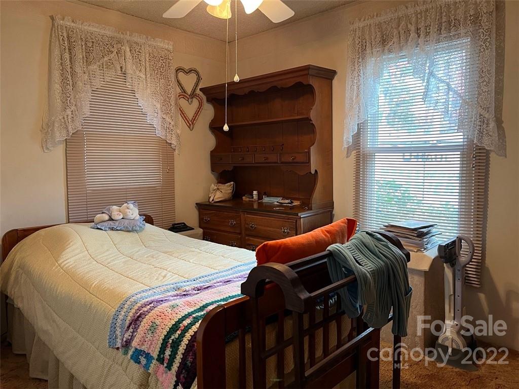 396 Jacobs Road Bryson City, NC 28713 - Photo 17 of 43 a bedroom with two beds and a chandelier