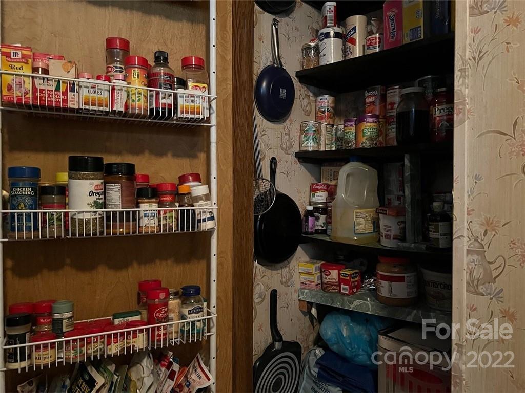 396 Jacobs Road Bryson City, NC 28713 - Photo 21 of 43 a store room with lots of different colored cloths and kitchen view