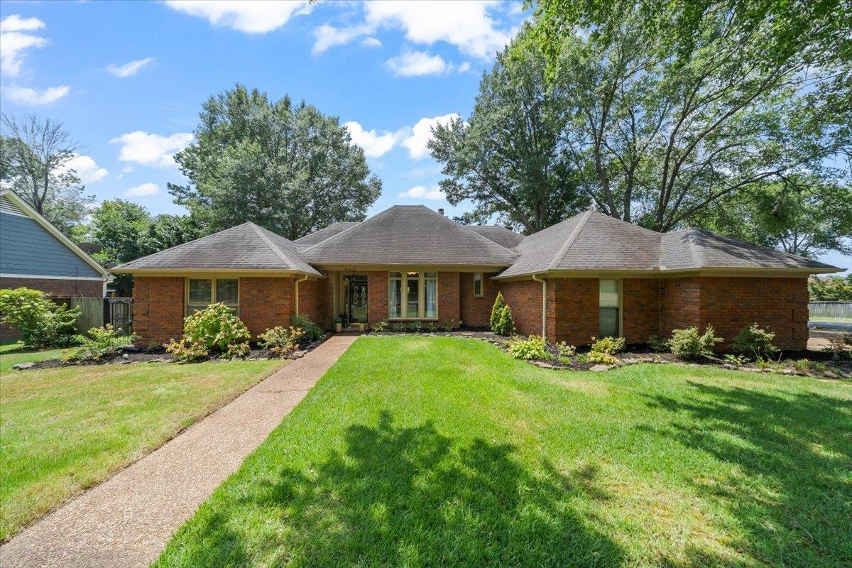 a front view of a house with yard patio and green space