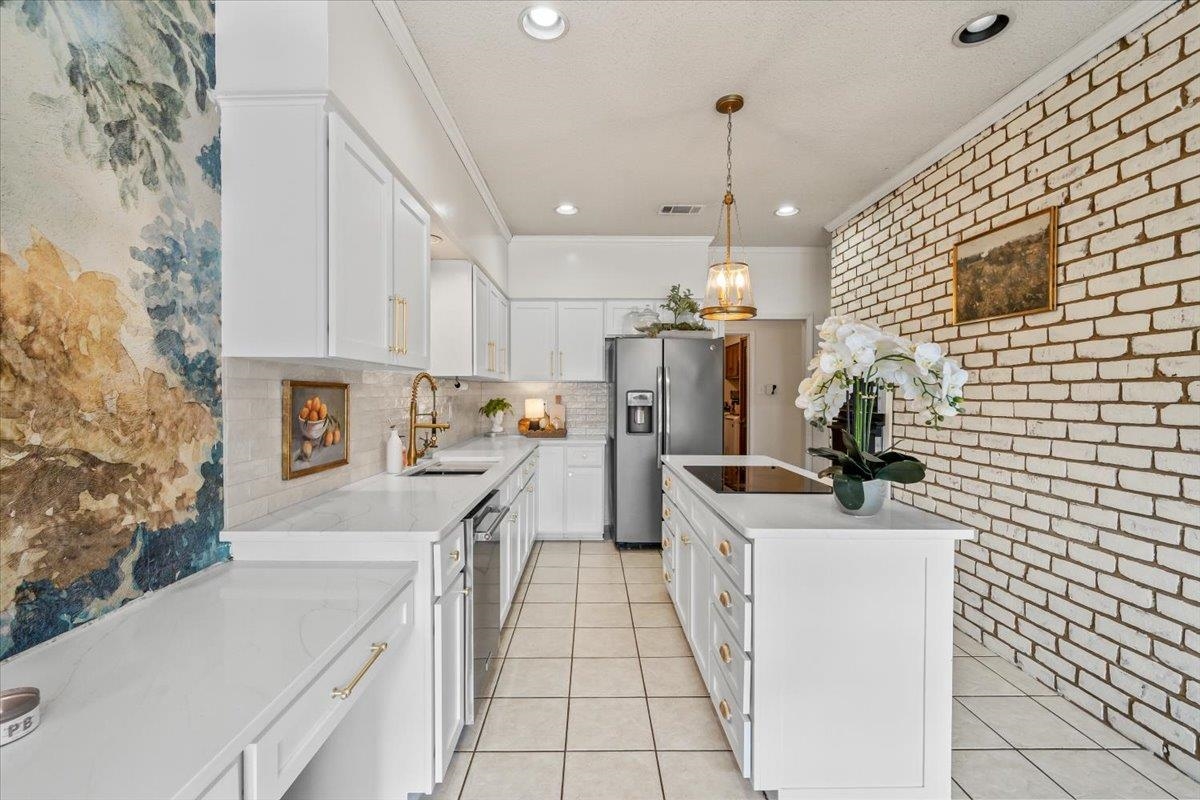 8417 Bazemore Road Memphis, TN 38018 - Photo 14 of 39 a kitchen with a sink a stove top oven a refrigerator and a stove