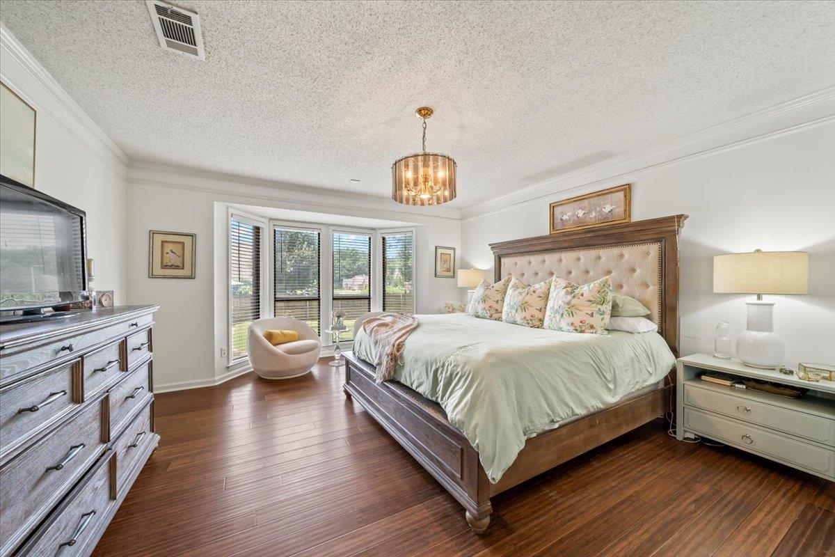 8417 Bazemore Road Memphis, TN 38018 - Photo 19 of 39 a bedroom with a bed and a chandelier