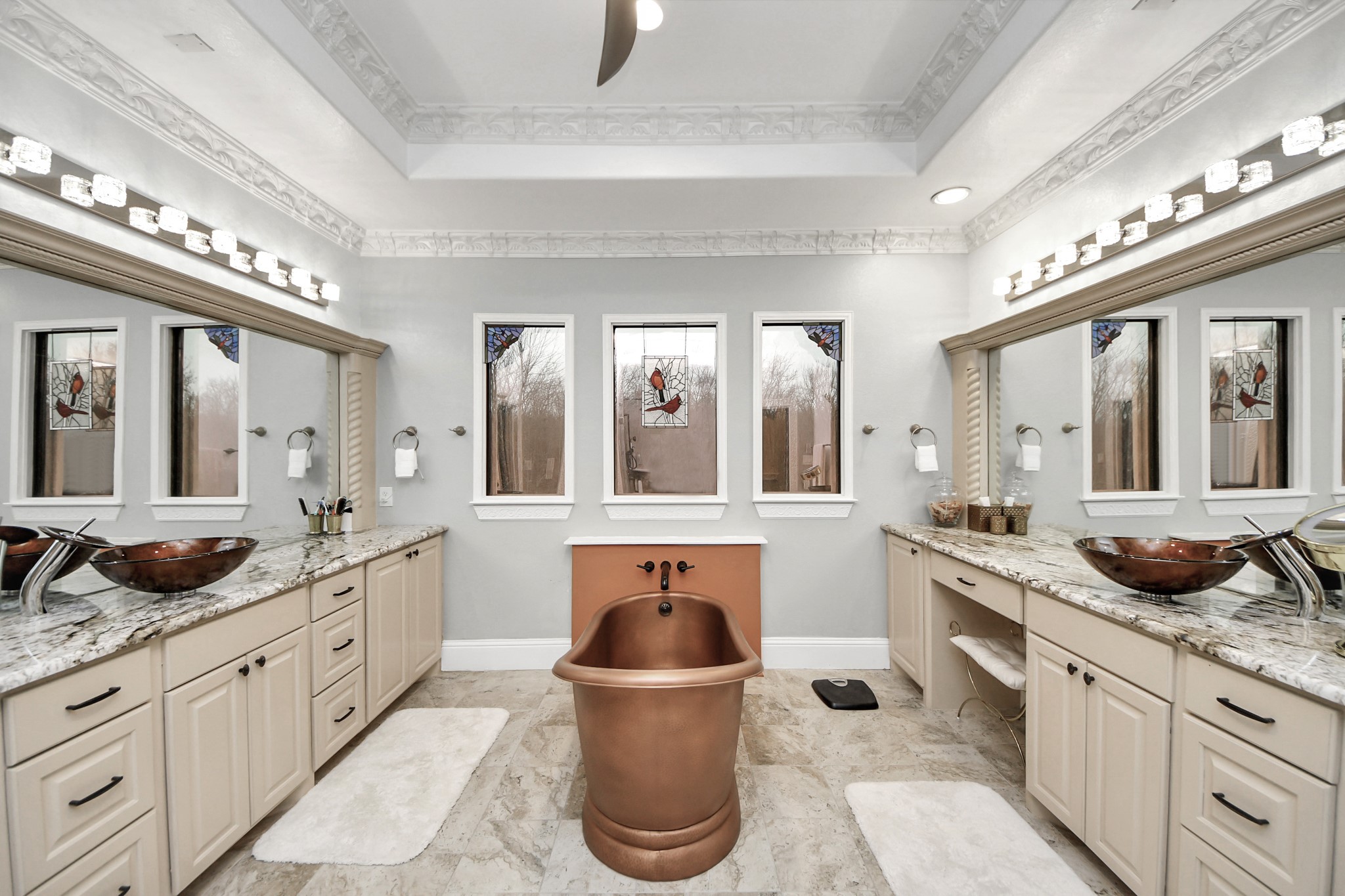 11503 Renaissance Drive Montgomery, TX 77356 - Photo 19 of 50 This spacious, modern primary bathroom characterized by a bright, airy aesthetic and high-end symmetrical layout and features a cylindrical copper-toned bathtub and features dual separate vanity areas.