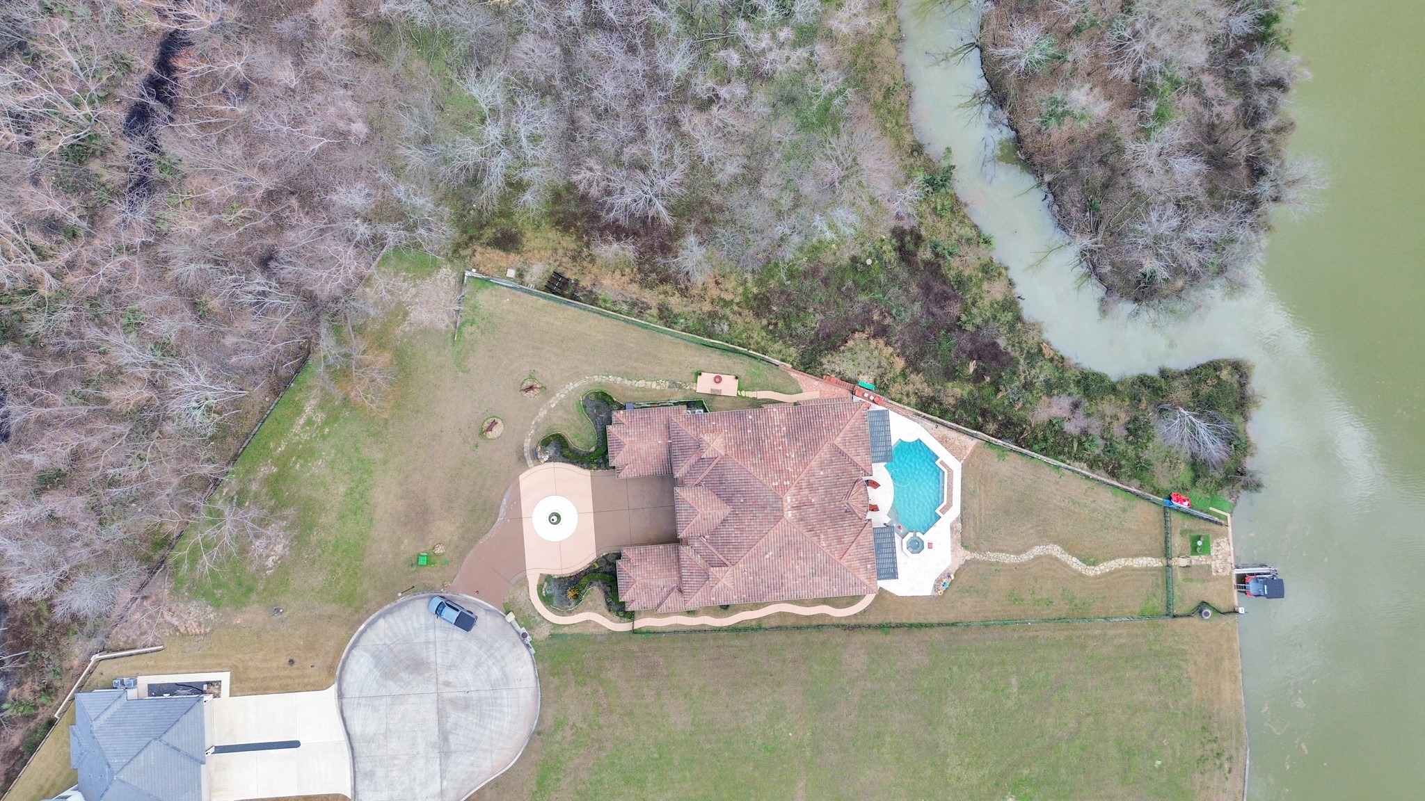 11503 Renaissance Drive Montgomery, TX 77356 - Photo 44 of 50 This exceptional waterfront property sits on a tranquil canal with direct access to Lake Conroe, offering a private and refined lakefront lifestyle. The expansive lot provides a serene backdrop for outdoor living, complete with a resort-style pool, spacious patios, and picturesque water views. A private dock allows for effortless boating and recreation, making this an ideal retreat for those seeking elegance, privacy, and seamless access to lake life.