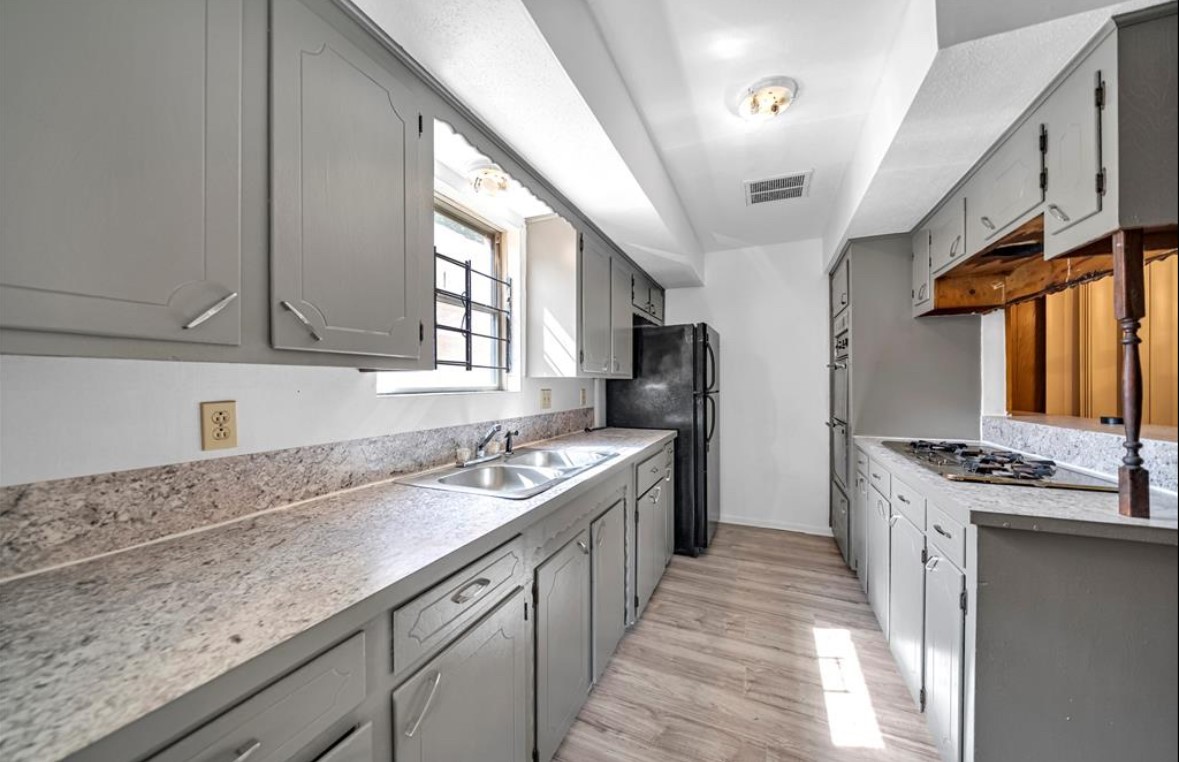 8447 Sterlingshire Street Houston, TX 77078 - Photo 7 of 26 a kitchen with stainless steel appliances granite countertop a sink stove and refrigerator