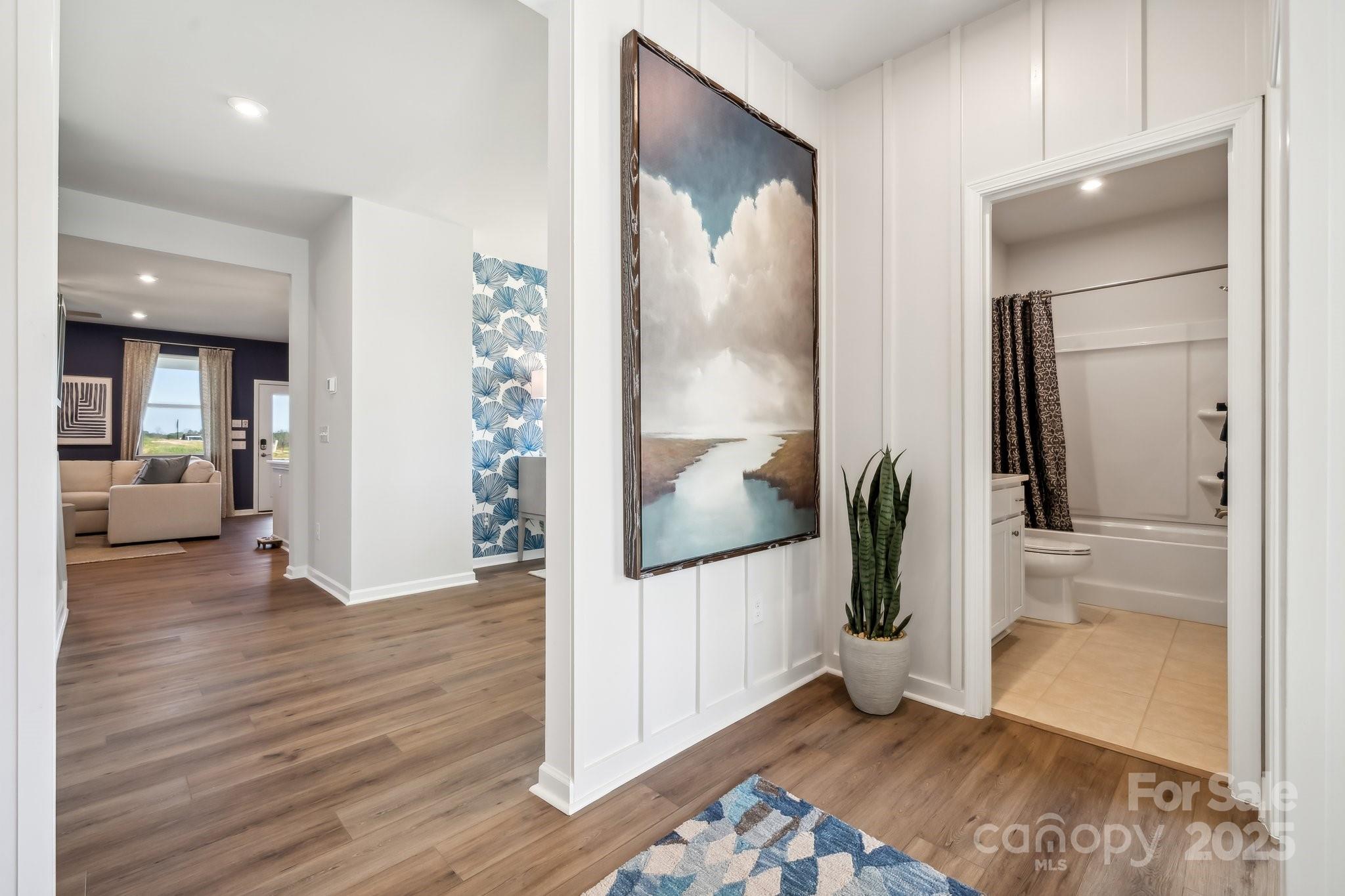 6417 Alanbrook Road, Unit 6 Charlotte, NC 28215 - Photo 6 of 25 a view of a hallway view with wooden floor and windows