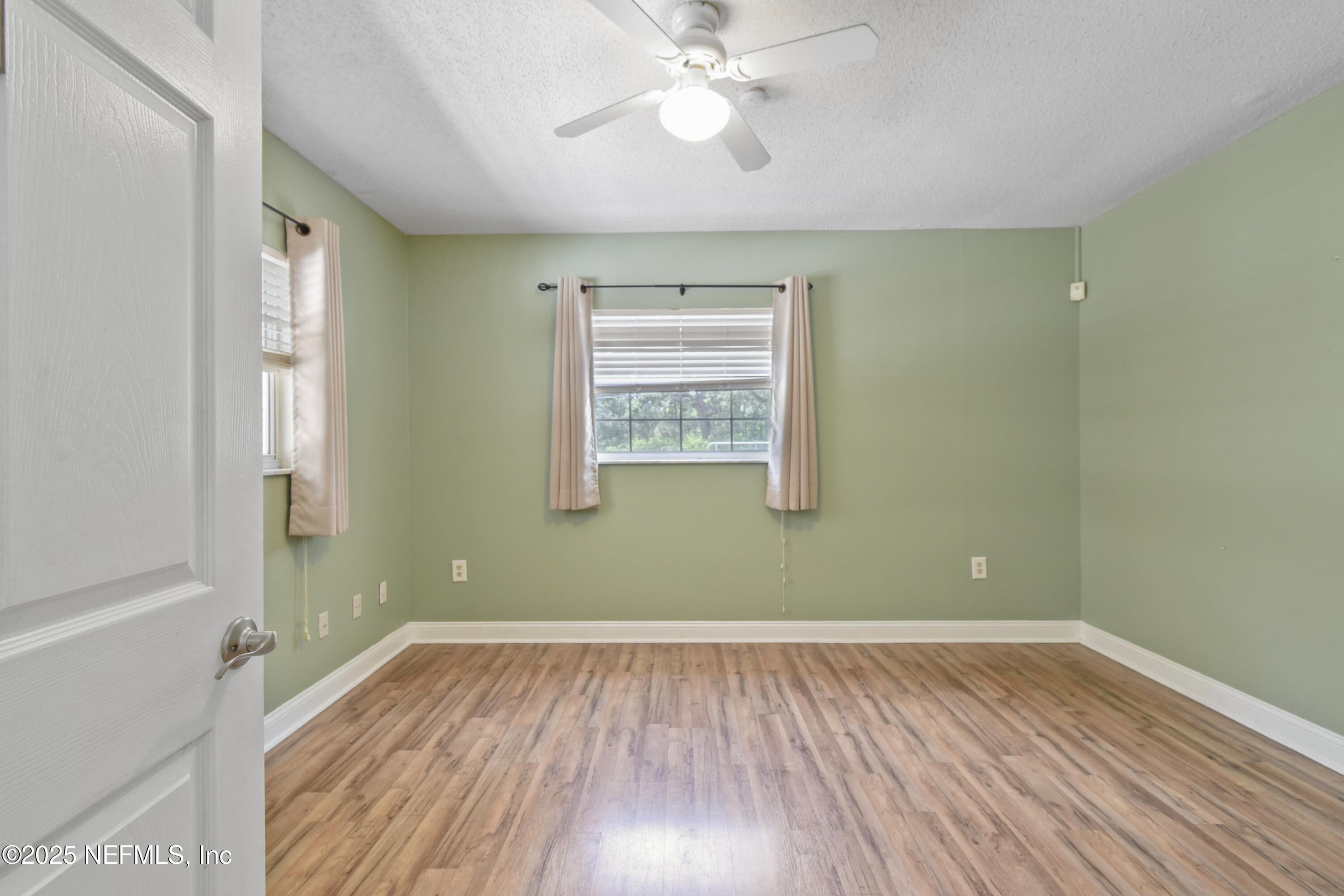 2706 Old Moultrie Road St. Augustine, FL 32086 - Photo 16 of 31 wooden floor in an empty room with a window