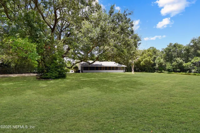 a view of house with yard and green space
