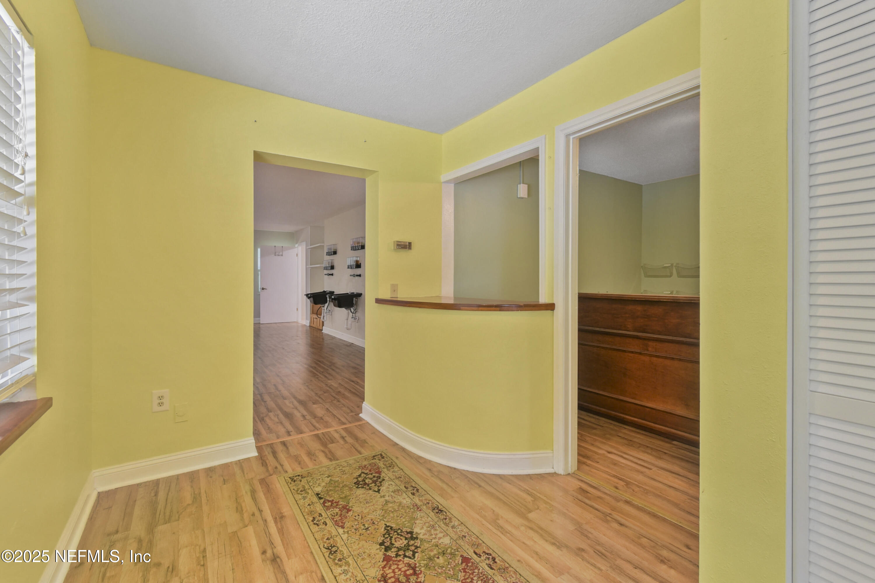 2706 Old Moultrie Road St. Augustine, FL 32086 - Photo 2 of 31 a view of a hallway with wooden floor and a living room