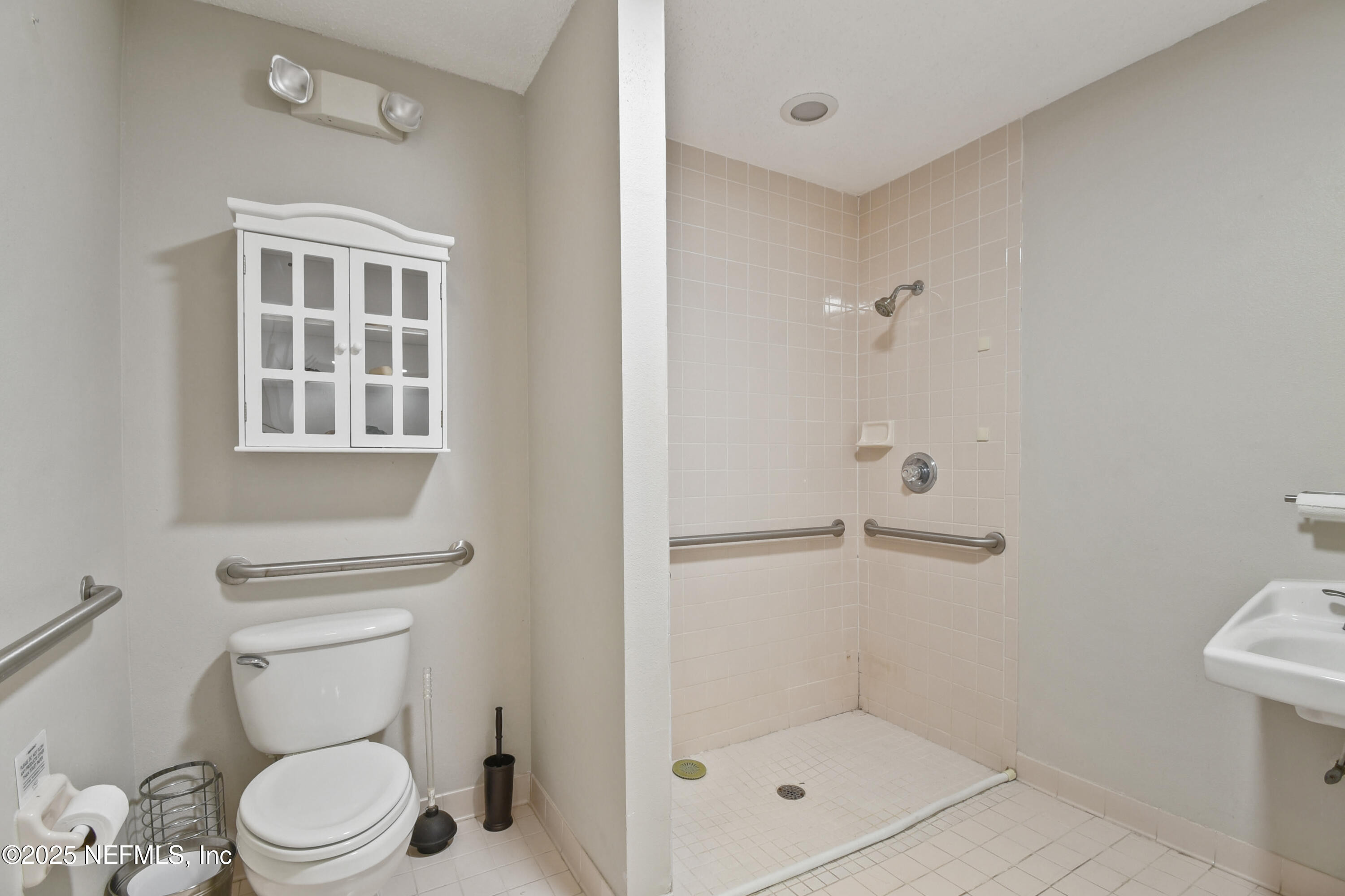 2706 Old Moultrie Road St. Augustine, FL 32086 - Photo 7 of 31 a white toilet sitting next to a bathroom sink