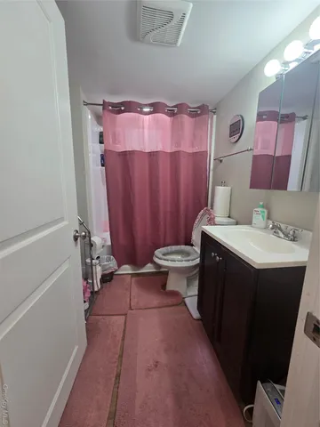 a bedroom with furniture and a gym machine