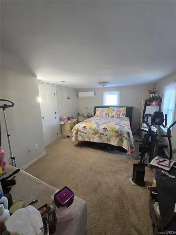 a bedroom with a bed and flat screen tv