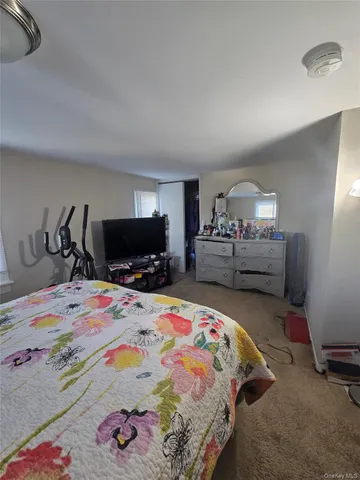 a bedroom with a bed and a tv